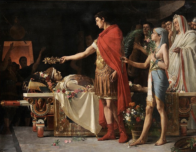 Augustus placing a crown and flowers on the body of Alexander the Great in his tomb.